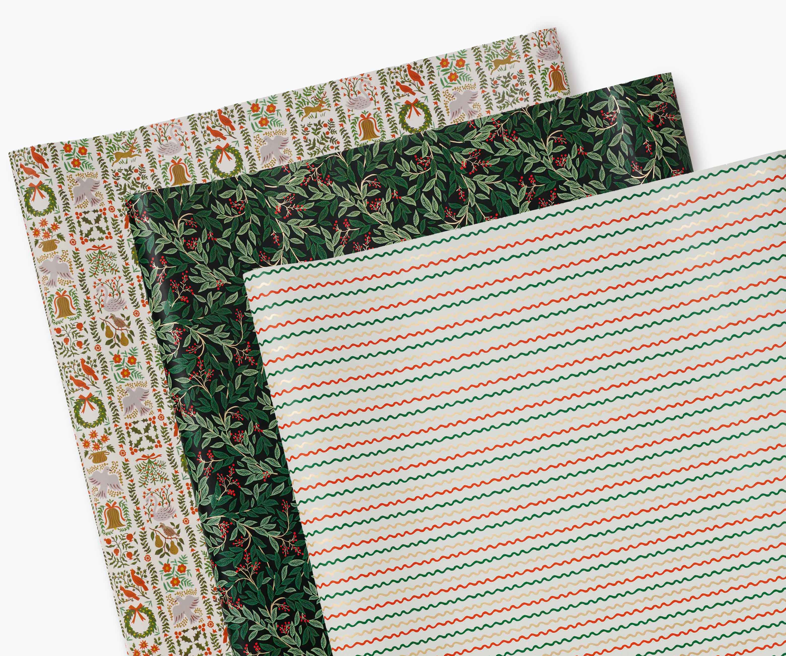 Three rolls of green and red vintage Christmas wrapping paper