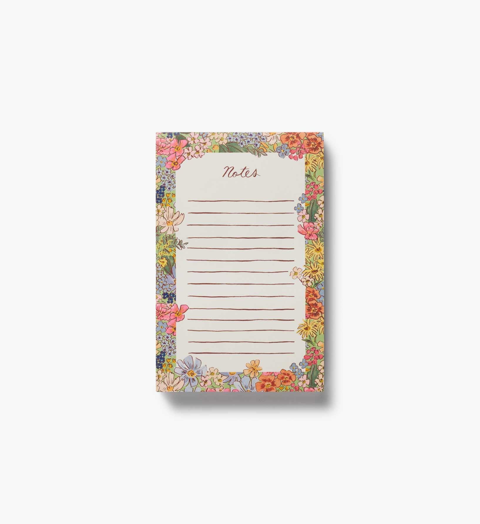 Floral notepad with lined paper on a white background